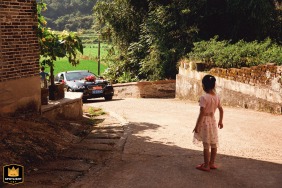In Jishui County, Jiangxi Province, China, a little girl gazes at the wedding car with great anticipation.